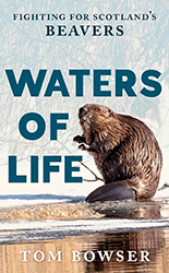 Book cover of 'Waters of Life: Fighting for Scotland's Beavers' by Tom Bowser. A wet beaver sits upright on a rock at the icy edge of a river in winter, holding a small twig in its front paws as if gnawing on it. Its dark brown fur is slicked with water and its flat, paddle-shaped tail is visible beneath it. Behind the animal, bare reeds and branches create a pale, wintry backdrop. The title is displayed in large teal bold lettering across the centre of the cover, with the subtitle and author's name in smaller text at the top and bottom respectively.